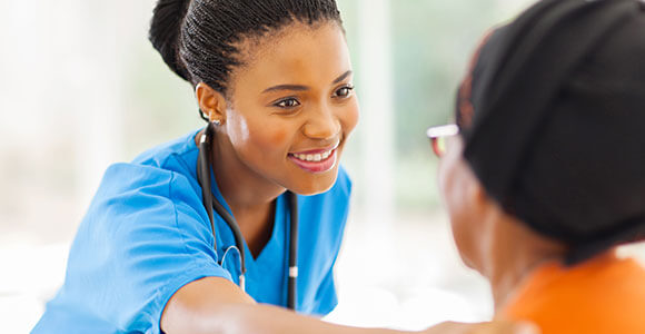 Nurse reaching out to comfort patient by the shoulder.